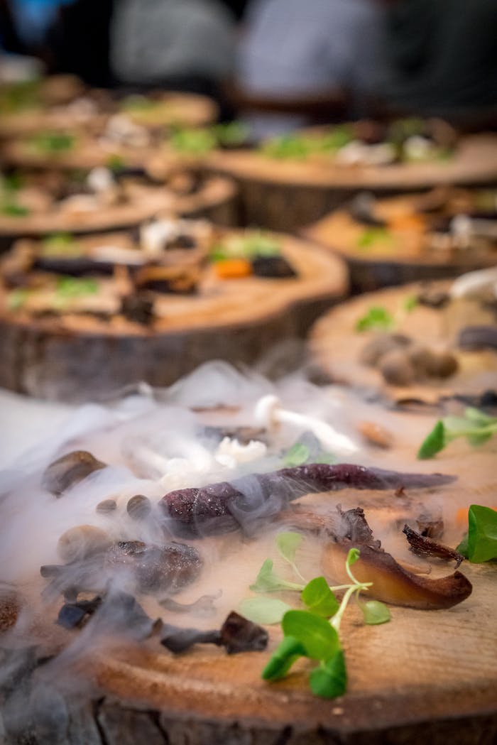 Artfully presented mushroom appetizers with a dramatic smoke effect on wooden platters, ideal for food enthusiasts.